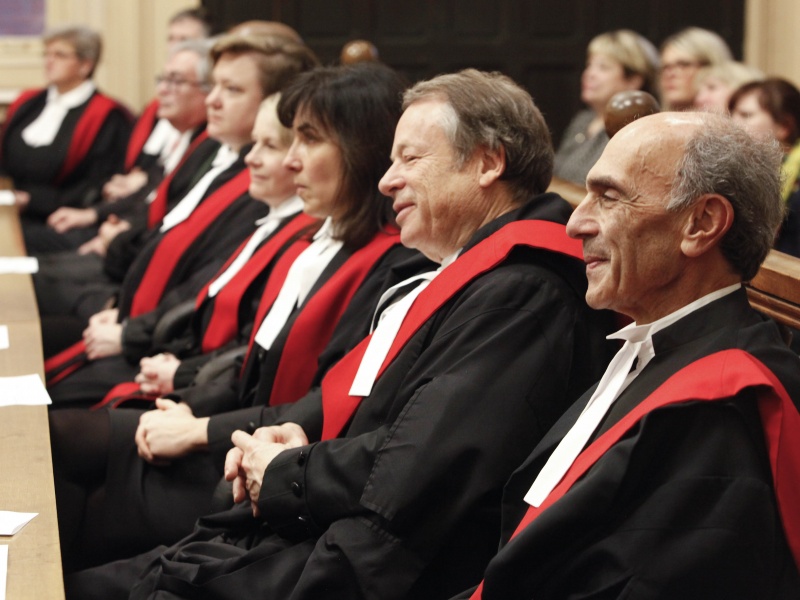 A row of judges sitting in a courtroom. 