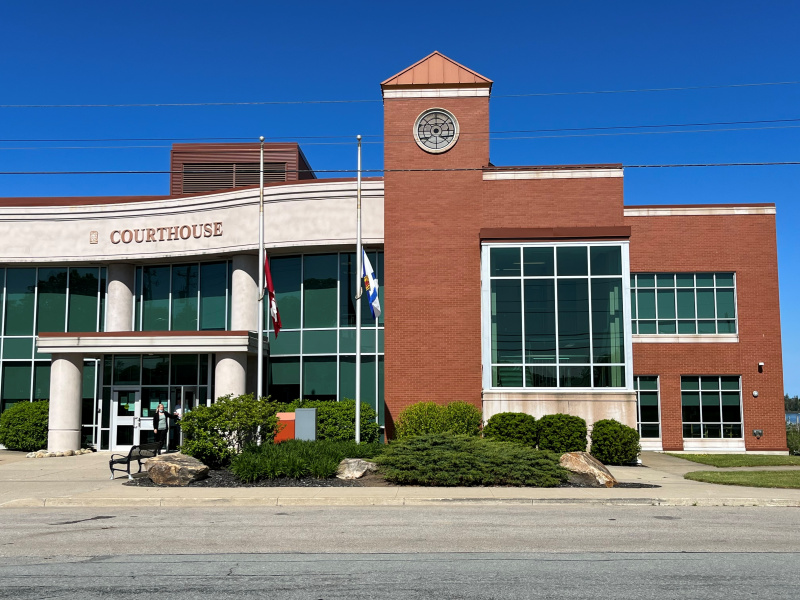 Brick and glass building under a blue sky. 