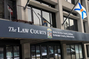 Front Entrance of the Law Courts Building with Canada and Nova Scotia flags out front.