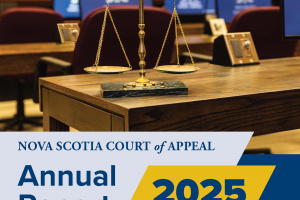 The cover of the Nova Scotia Court of Appeal 2025 Annual Report. The photo shows the scales of justice on a table in a courtroom. Computer monitors show the crest of the Court of Appeal. The cover includes the words Nova Scotia Court of Appeal Annual Report 2025, The Law Courts, 5th Floor, 1815 Upper Water St., Halifax, NS, B3J 1S7. www.courts.ns.ca.